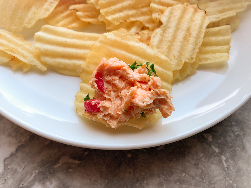 Pimento cheese spread on a potato chip.