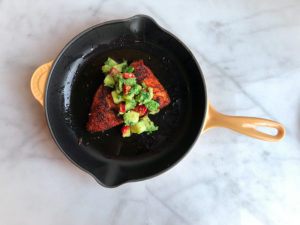 Blackened Salmon in pan with pineapple avocado salsa